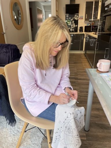 Karen painting clay in Emma's kitchen